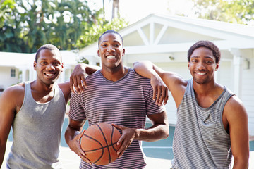 Fototapeta premium Group Of Young Men Playing Basketball Match