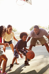 Family Playing Basketball Game At Home