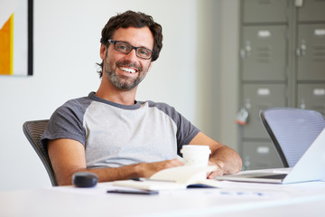 Portrait Of Casually Dressed Man Working In Design Studio