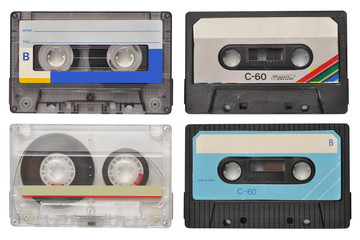 Four retro cassette tapes isolated on white