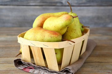 Juicy pears in wooden crate