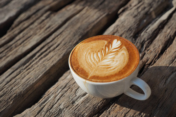 cup of coffee latte art on the wood background in vintage color