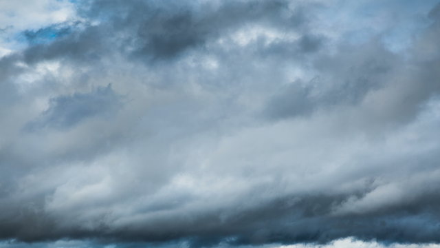 Dark clouds rolling past in stormy wind