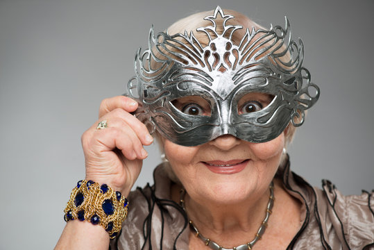 Elderly woman wearing glamorous mask