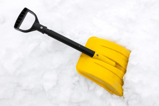 Yellow Snow Shovel On White Snow