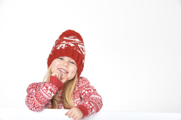 Smiling beautiful blond girl in a red winter cap and sweater wit