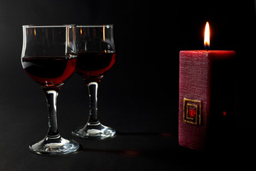 Beautiful Red Candle and Two Glass Cups of Red Wine Isolated