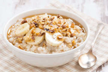oatmeal with banana, honey and walnuts in bowl