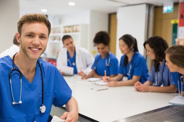 Medical student smiling at the camera during class