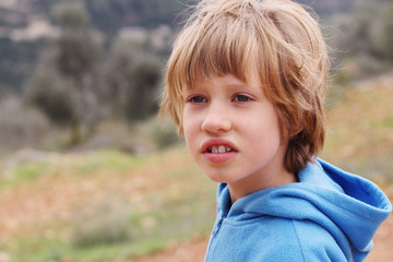 Outdoor portrait of 6 years old boy