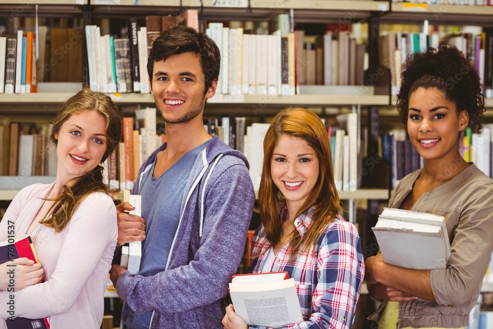 Poster students in a line smiling at camera holding books