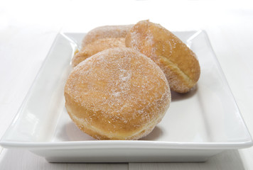 baked donut with sugar on a plate