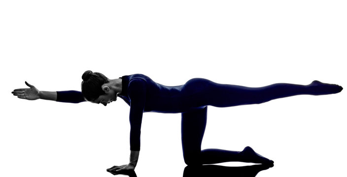 woman exercising balancing table pose yoga silhouette