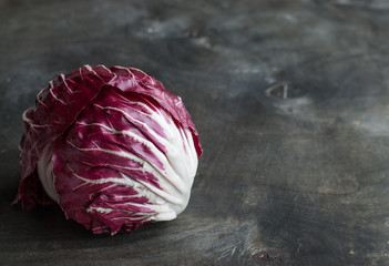 Obraz premium Radicchio red salad on wooden background. Horisontal