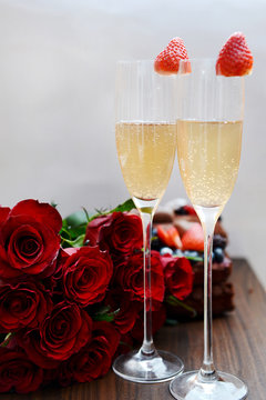Champagne Glasses with Strawberries and Bunch of Flowers