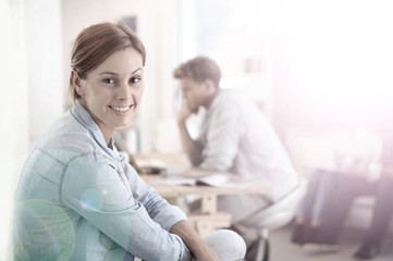 Fototapeta premium Smiling woman sitting in shared apartment