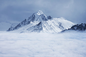 Fototapeta na wymiar snowed mountain's top over white clouds, Leh Ladakh, India