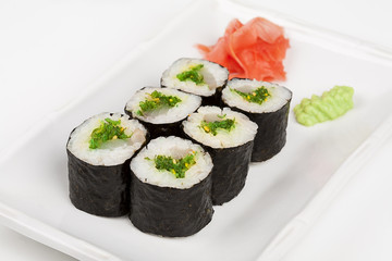 Sushi roll with fish and green salad.