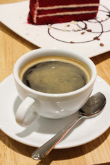 A cup of black coffee on the wood table