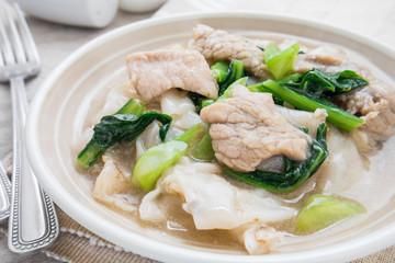 Fried noodle with pork and kale soaked in gravy
