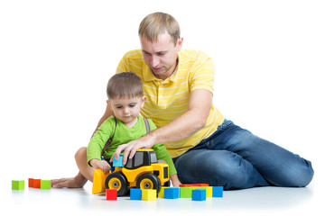 child and his dad repair toy tractor