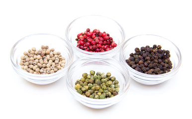 Bowls with mixed peppers on white background