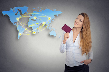 tourist young woman holding passport looking at world map