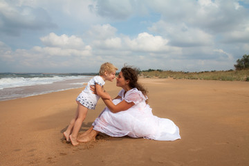 Mother and daughter enjoying time at beach
