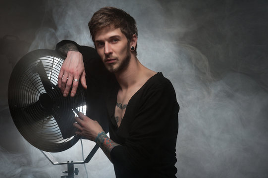 Men with fan on the smoke