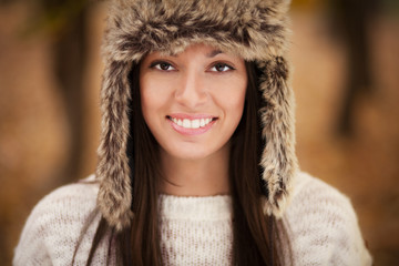 Beautiful young woman with brown fur hat