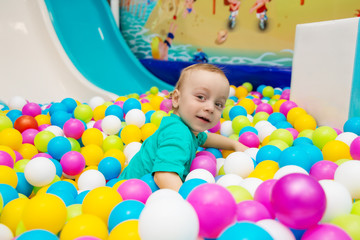 Fototapeta na wymiar little boy playing with balls