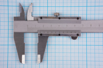 Closeup of vernier-caliper on graph paper