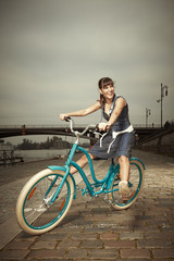 Obraz na płótnie Canvas Nice woman rides retro bicycle