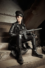 Naklejka premium Woman with automat in uniform