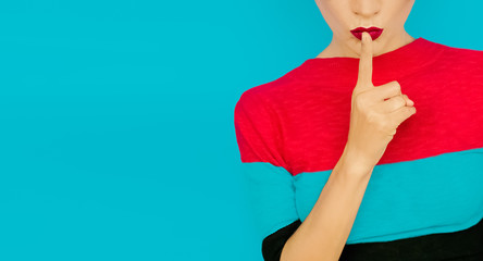 secret girl on blue background. Red lips trend - obrazy, fototapety, plakaty