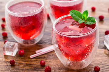 Cranberry cocktail with mint garnish.