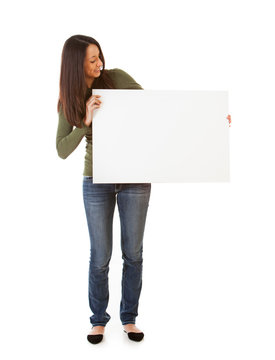 Smiling Woman Looks Over At Blank Poster Board