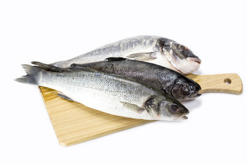 raw fish on a cutting board and knife