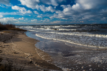 Baltic sea beach with blue cloudy sky