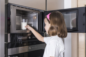 Fototapeta na wymiar Child preparing a glass of milk