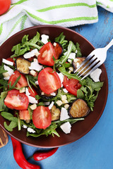 Eggplant salad with tomatoes, arugula and feta cheese,