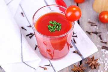 Tomato juice in glass and fresh vegetables