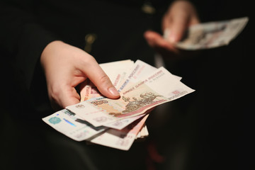 Close-up of a women hands counting Russian banknotes