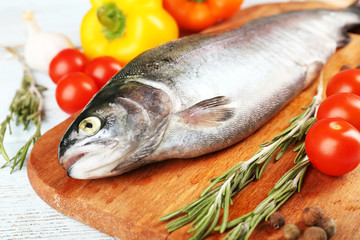 Fresh raw fish and food ingredients on table