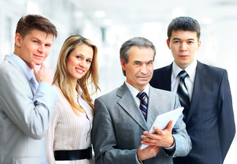 Portrait of businessman leading his team at office