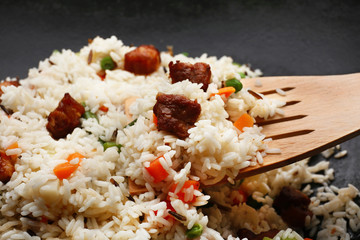 Tasty rice preparing in wok, close-up