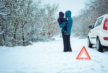 woman with a child on the winter road.