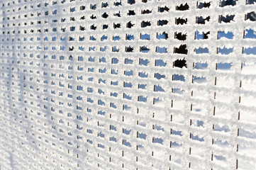 Detail of net, fence covered by snow and hoarfrost.