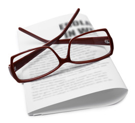 Glasses and newspapers, close-up