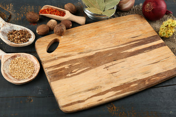 Different spices and herbs with cutting board